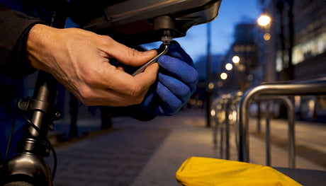 Hands securing a commuter bike light mount