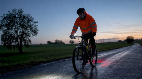 Cyclist using safety lights on urban night ride