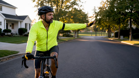 Cyclist signaling a turn on city street