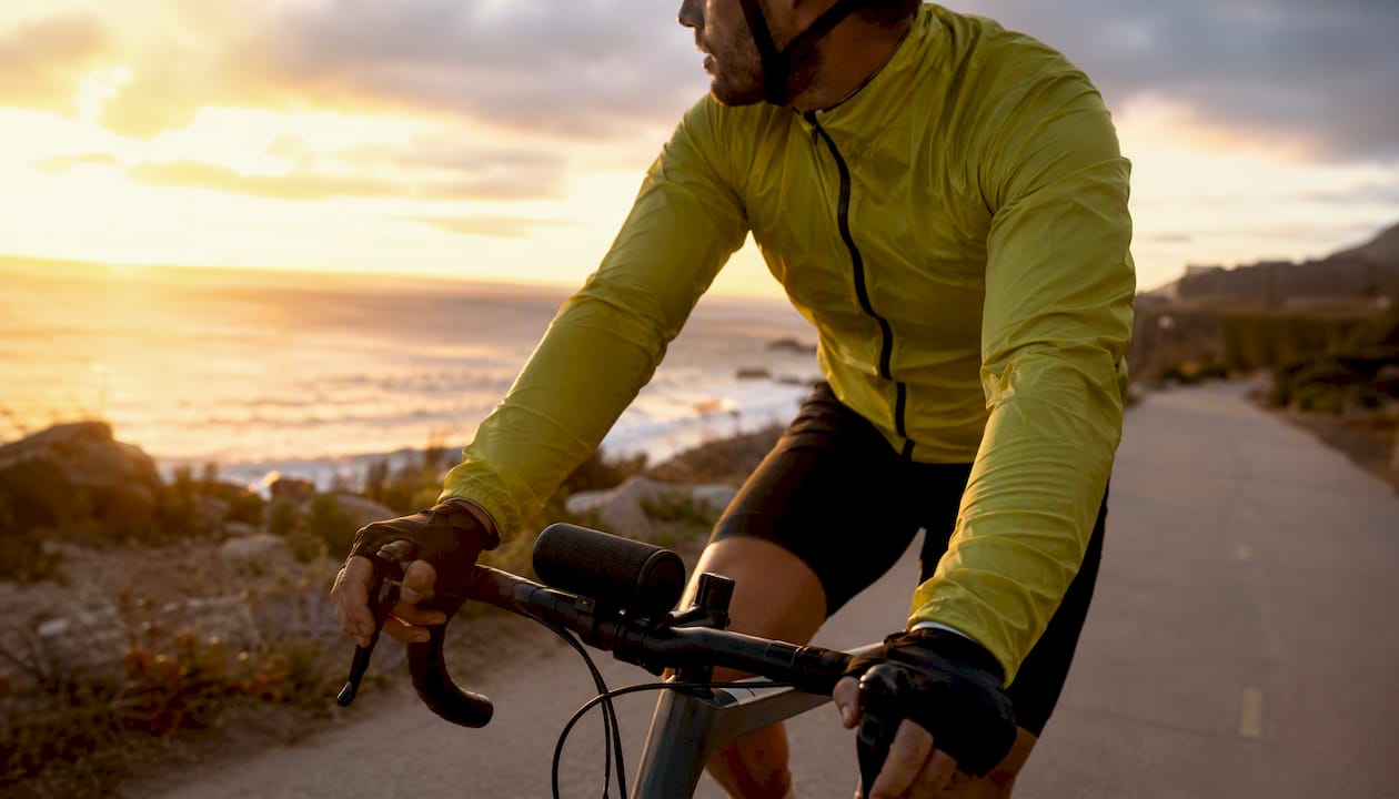 Cyclist using handlebar speaker while riding