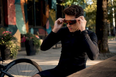 Cyclist adjusting anti-glare cycling lenses outdoors
