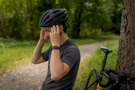 Cyclist adjusting low profile bike helmet