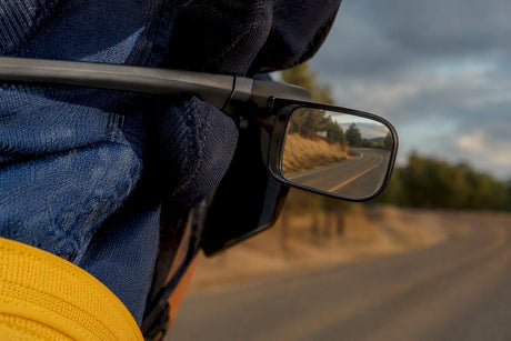 Rear-view mirror optic reflecting a cycling road