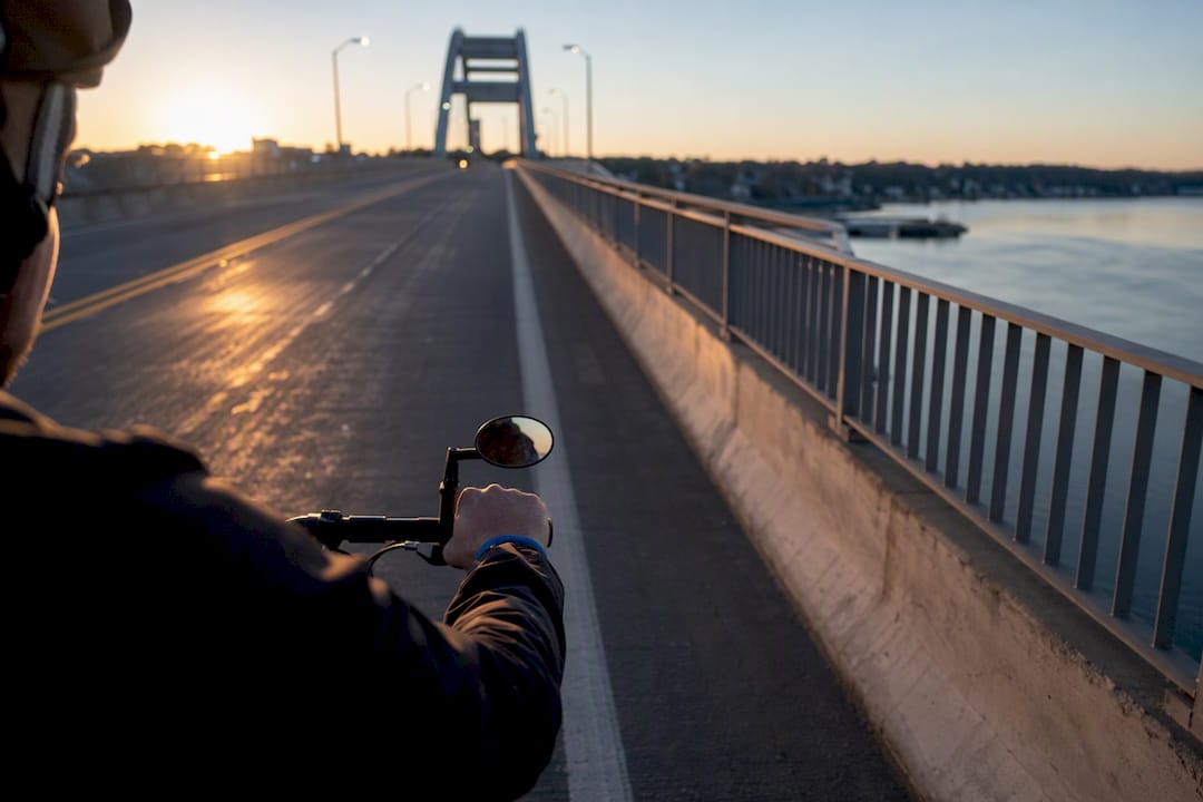 Commuter cyclist checking traffic with helmet mirror