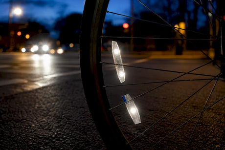 Wheel reflectors flashing at dusk intersection