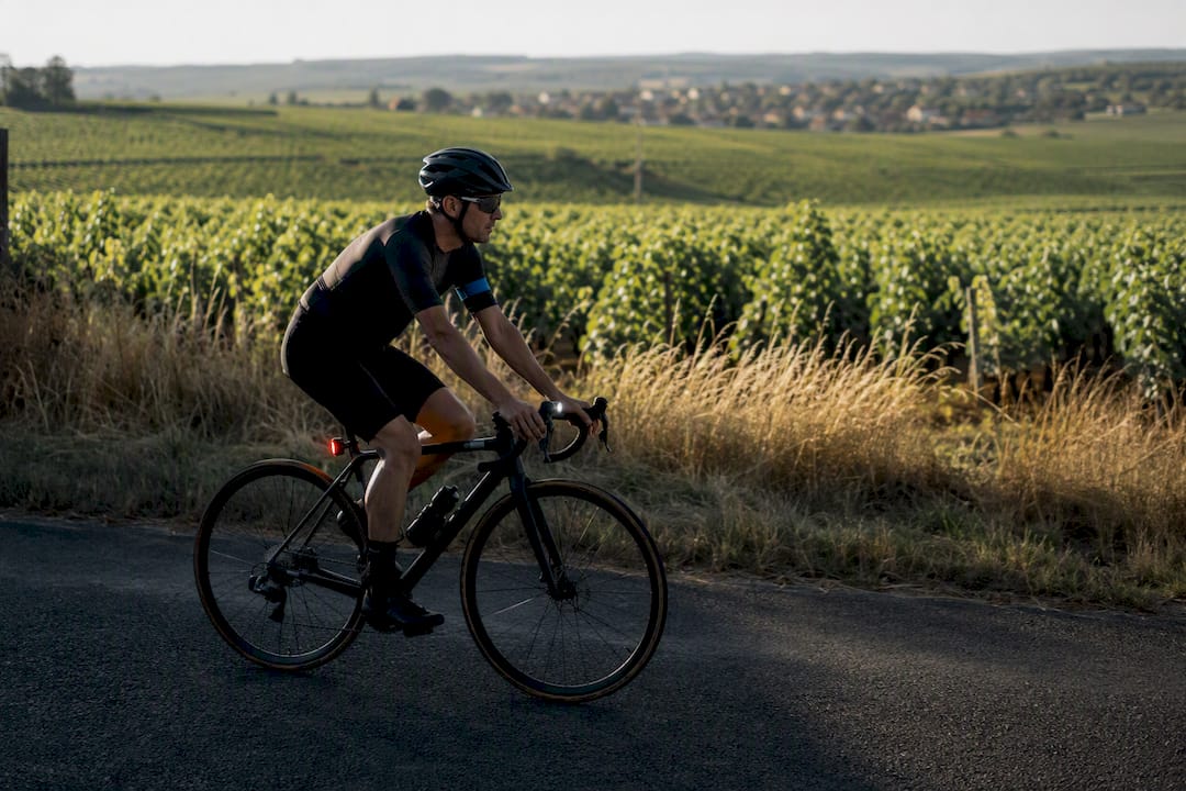 Cyclist using daytime lights on French road