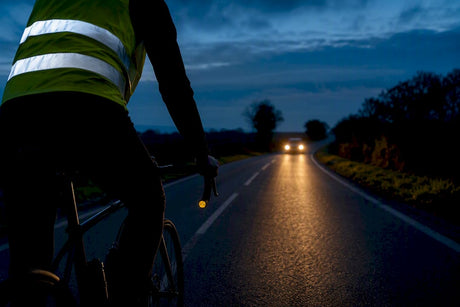 Cyclist wearing reflective gear on French road